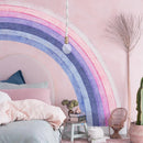 Decorative rainbow wall in a bedroom with a bed and plants, Obroi