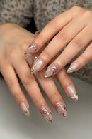 Close-up of hands with decorative nail art on a neutral background, Obroi