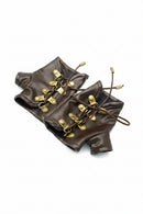 A pair of miniature brown faux-leather doll boots with brass-tone metal eyelets, laces, and drawstrings, displayed on a clean white background, Obroi