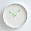 White wall clock with green hands on a white background, Obroi