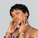 Woman with styled hair and jewelry against a plain background, Obroi
