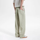 Person wearing light green pants on a white background, Obroi