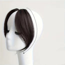 Pack of 2 black brown hair extensions on a mannequin head with close-up of one extension, Obroi
