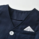 Navy blue blazer with a white button and pocket square on a light gray background, Obroi