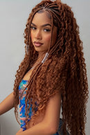 Woman with long braided hair next to a bundle of curly hair extensions, Obroi