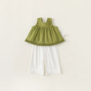 Green top and white pants set on a light beige background, Obroi