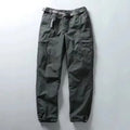 Green cargo pants on a light gray background, Obroi