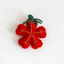 Red felt flower with green stem on a white , Obroi