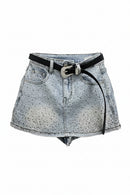 Light-wash denim mini skirt with a black belt and silver rhinestone buckle, shown flat on a white background, Obroi