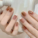 Close-up of hands with brown and white nail polish holding a white ceramic cup, Obroi