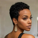 Woman with short, curly black hair wearing gold earrings against a neutral background, Obroi