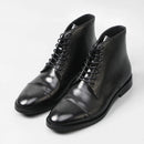 Pair of black leather boots on a white background