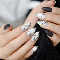 Close-up of hands with black and white marbled nail design on a blurred background, Obroi