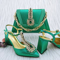 Green high-heeled shoes and matching handbag with decorative elements on a light background, Obroi