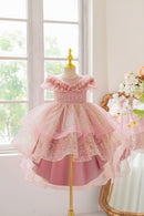 Pink children's dress on a mannequin with a decorative background, Obroi