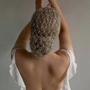 Person wearing a decorative headpiece with intricate design, back view, Obroi