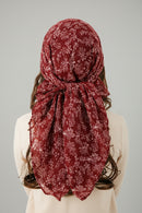 Red floral headscarf on a neutral background, Obroi