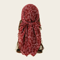 Red floral headscarf on a neutral background, Obroi