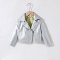 A metallic silver faux-leather moto jacket for kids, hanging on a wooden hanger against a plain white background, Obroi