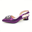 Purple high-heeled shoe with decorative embellishments on a white background, Obroi