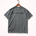 Gray t-shirt with 'US Air Force' text on a hanger against a white background, Obroi