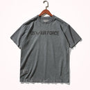 Gray t-shirt with 'US Air Force' text on a hanger against a white background, Obroi