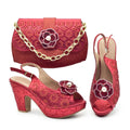 A women's matching accessory set featuring a red clutch handbag with a gold chain strap, a red slingback high-heel shoe with a flower embellishment, and a matching red slingback high-heel shoe, all on a white background with the brand name Obroi in the top left corner.