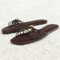 Pair of brown sandals with gold accents on a light gray background, Obroi