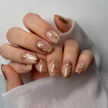 Nails with gold accents on a white background, Obroi