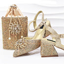 Gold glittery handbag and high-heeled shoes on a white background, Obroi