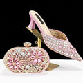 Pink high-heeled shoes and matching clutch with rhinestone embellishments on a black background, Obroi 