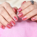 Close-up of hands with pink nail polish on a pink fabric background, Obroi