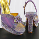 Purple high-heeled shoes with rhinestone embellishments on a black , Obroi.