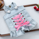 Light blue denim dog coat with pink laces on a white surface, Obroi