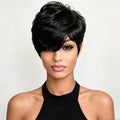 A woman modeling a short, layered black wig with a side-swept bang and soft textured ends against a plain light background, Obroi