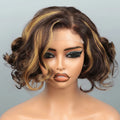 A short wavy wig with dark brown and golden blonde highlights, styled on a mannequin head against a light gray background. A watermark reading 'Obroi' and a color code label 'Obroi' are overlaid on the image.