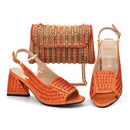 Orange high-heeled shoes with a matching handbag on a white background, Obroi