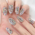 Nails with sparkling rhinestone design on a hand, Obroi