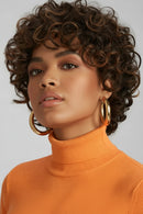 Woman with curly hair wearing gold hoop earrings and an orange turtleneck sweater, Obroi