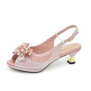 Pink high-heeled shoe with decorative bow and embellishments on a white background, Obroi
