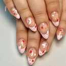 Nails with pink and red heart designs on a neutral background, Obroi