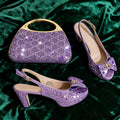 Purple embellished handbag and high-heeled shoes on a green fabric background, Obroi