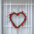 Heart-shaped wreath with red berries on a white window pane background, Obroi