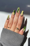 Nails with green and beige gradient design on a neutral background, Obroi
