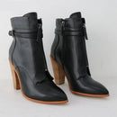 Black ankle boots with wooden heel on a white background, branded 'Obroi'.