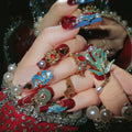 Close-up of hands wearing various decorative rings with intricate designs and gemstones, Obroi