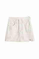 White denim skirt with floral embroidery on a white background, Obroi