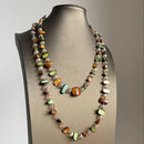 Necklace with multicolored beads on a mannequin bust against a neutral background, Obroi