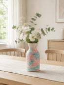 Decorative vase with flowers on a table in a bright room, Obroi