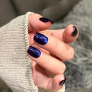 Hand with dark blue nail polish on a blurred background, Obroi
